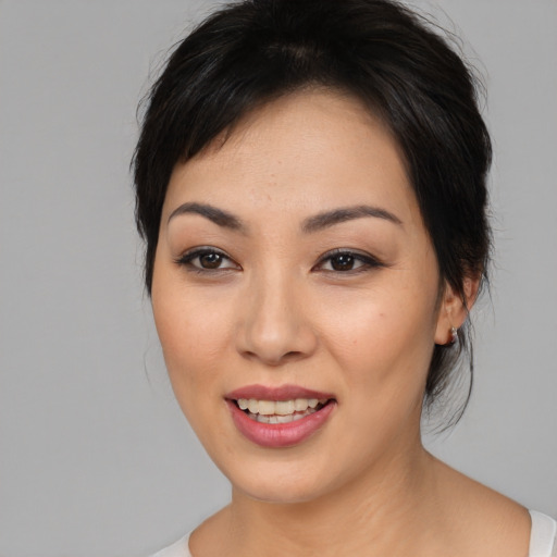 Joyful asian young-adult female with medium  black hair and brown eyes
