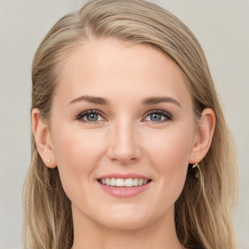 Joyful white young-adult female with long  brown hair and blue eyes