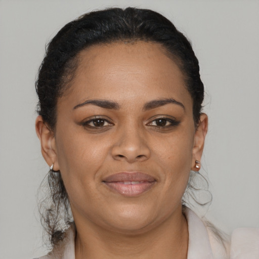 Joyful black young-adult female with medium  brown hair and brown eyes