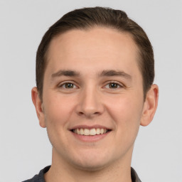 Joyful white young-adult male with short  brown hair and brown eyes