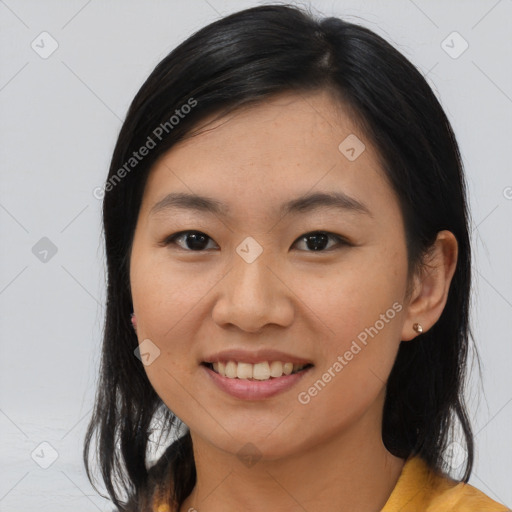 Joyful asian young-adult female with medium  black hair and brown eyes