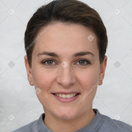 Joyful white young-adult female with short  brown hair and grey eyes