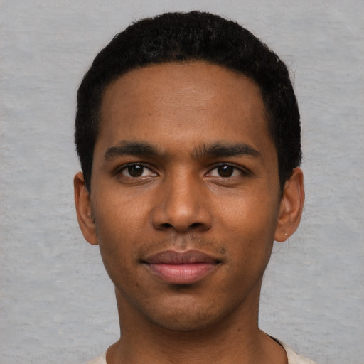 Joyful black young-adult male with short  black hair and brown eyes