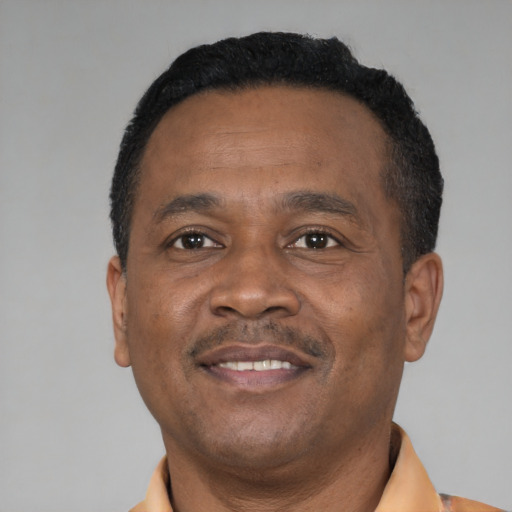 Joyful latino adult male with short  black hair and brown eyes