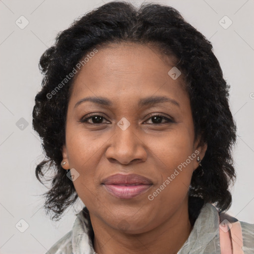 Joyful black adult female with medium  brown hair and brown eyes