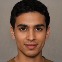 Joyful latino young-adult male with short  brown hair and brown eyes