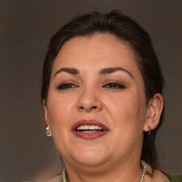 Joyful white adult female with long  brown hair and brown eyes