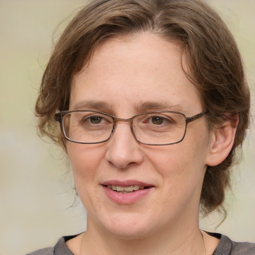 Joyful white adult female with medium  brown hair and blue eyes