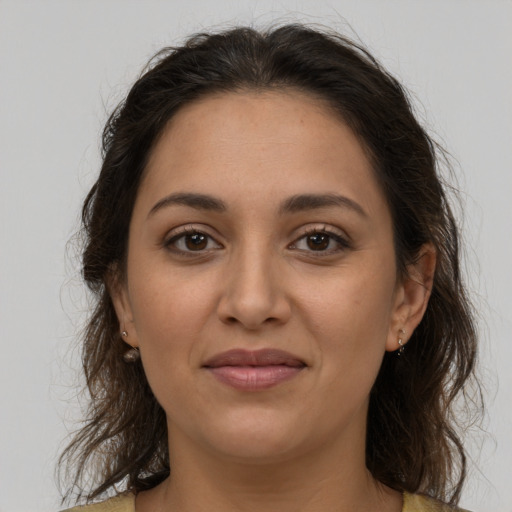 Joyful latino young-adult female with medium  brown hair and brown eyes