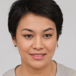 Joyful asian young-adult female with short  brown hair and brown eyes