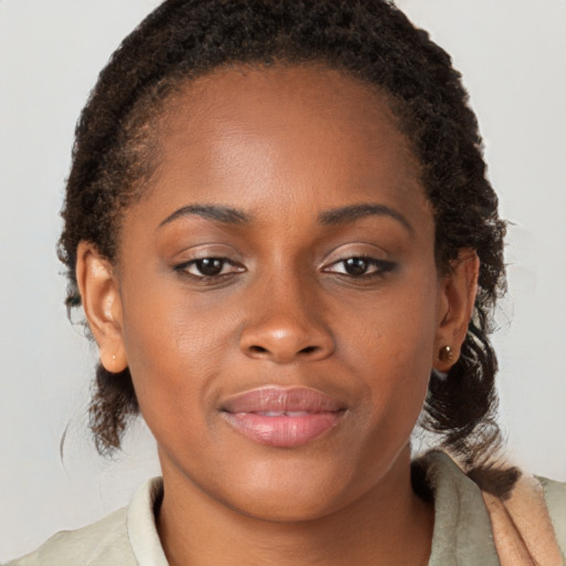 Joyful black young-adult female with medium  brown hair and brown eyes