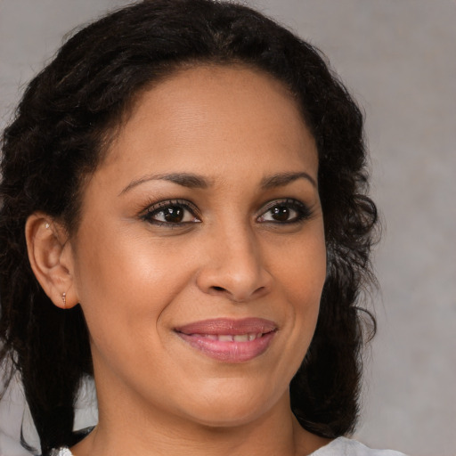 Joyful black young-adult female with medium  brown hair and brown eyes