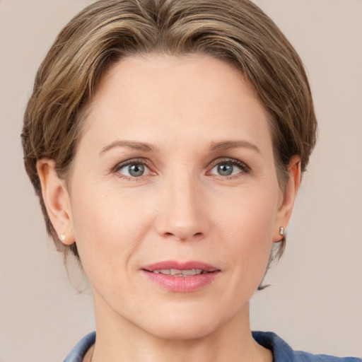 Joyful white adult female with medium  brown hair and grey eyes