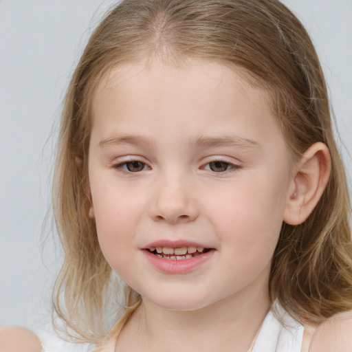 Joyful white child female with medium  brown hair and blue eyes