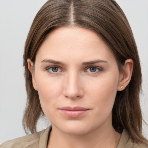 Joyful white young-adult female with long  brown hair and grey eyes