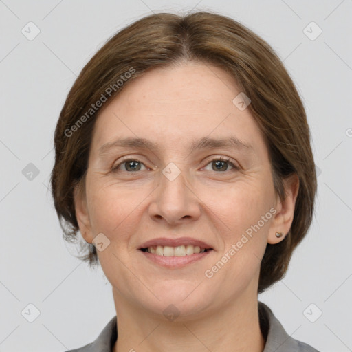 Joyful white adult female with medium  brown hair and grey eyes