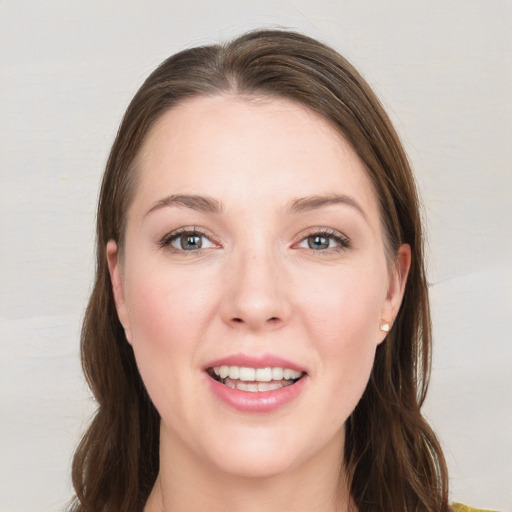 Joyful white young-adult female with long  brown hair and grey eyes