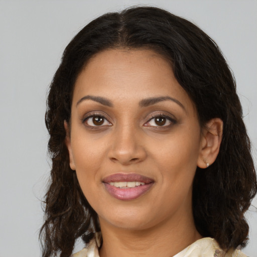 Joyful black young-adult female with medium  brown hair and brown eyes