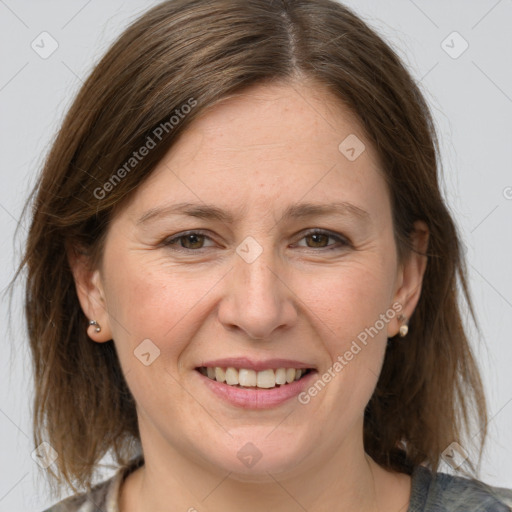 Joyful white adult female with medium  brown hair and grey eyes