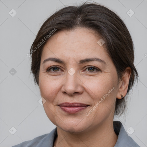 Joyful white adult female with medium  brown hair and brown eyes