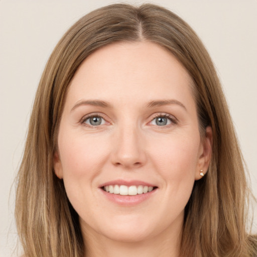 Joyful white young-adult female with long  brown hair and grey eyes