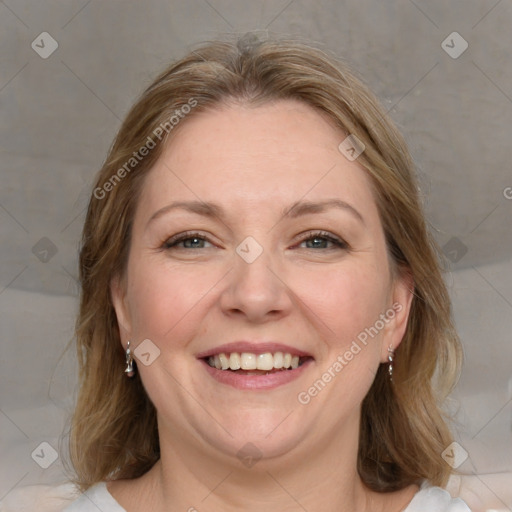 Joyful white adult female with medium  brown hair and blue eyes