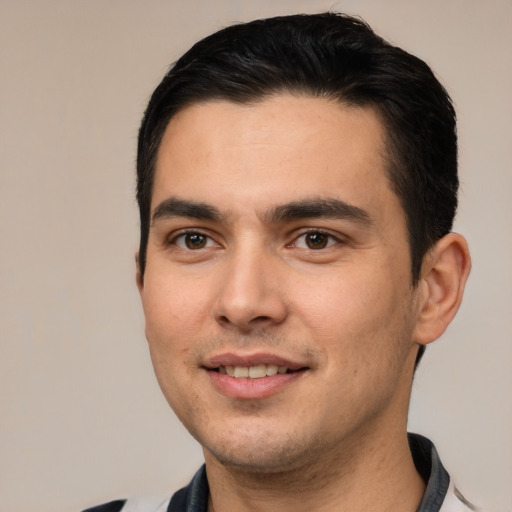 Joyful white young-adult male with short  black hair and brown eyes