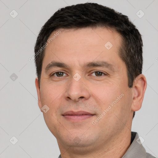 Joyful white adult male with short  brown hair and brown eyes