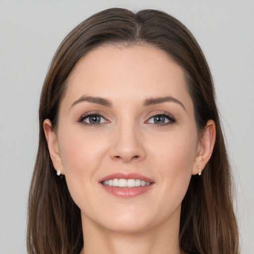 Joyful white young-adult female with long  brown hair and brown eyes