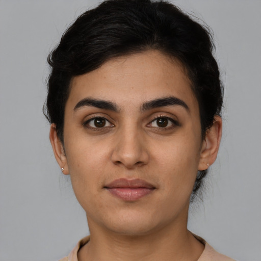 Joyful latino young-adult female with short  brown hair and brown eyes