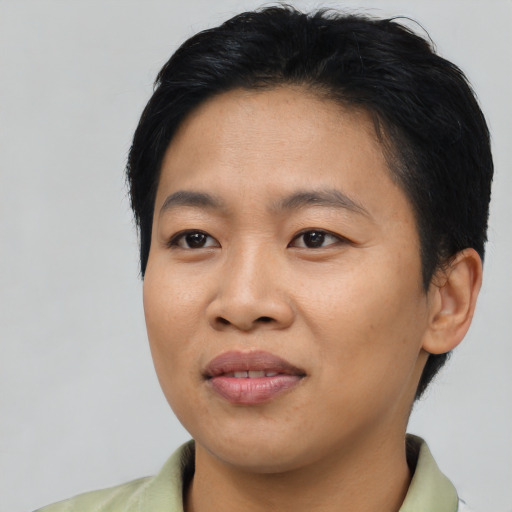 Joyful asian young-adult female with short  black hair and brown eyes