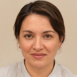 Joyful white adult female with medium  brown hair and brown eyes