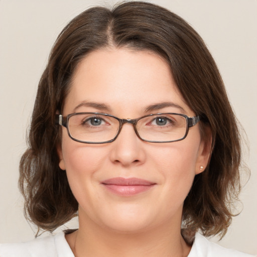 Joyful white young-adult female with medium  brown hair and green eyes