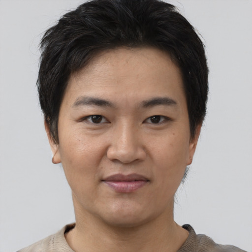 Joyful asian young-adult female with short  black hair and brown eyes