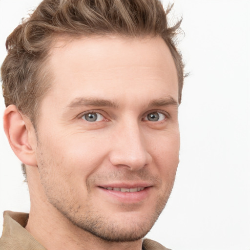 Joyful white young-adult male with short  brown hair and grey eyes