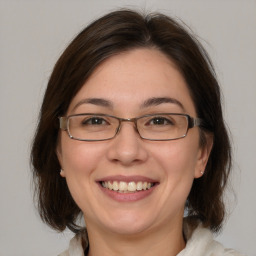 Joyful white adult female with medium  brown hair and brown eyes