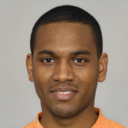 Joyful black young-adult male with short  black hair and brown eyes
