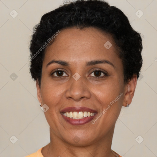 Joyful latino adult female with short  brown hair and brown eyes