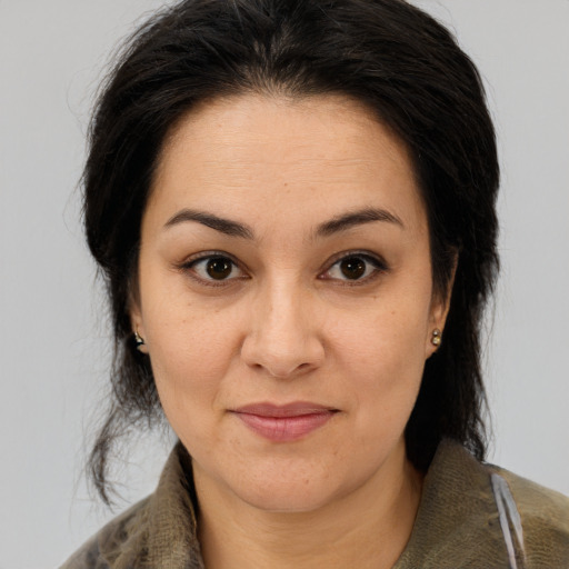 Joyful latino adult female with medium  brown hair and brown eyes
