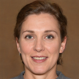 Joyful white adult female with medium  brown hair and grey eyes