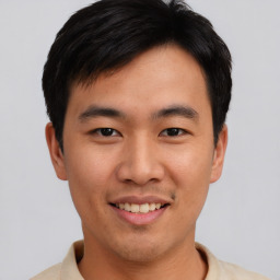 Joyful asian young-adult male with short  brown hair and brown eyes