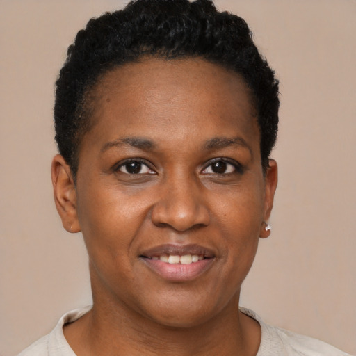 Joyful black young-adult female with short  brown hair and brown eyes