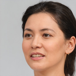 Joyful white adult female with medium  brown hair and brown eyes