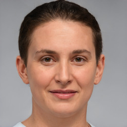 Joyful white adult female with short  brown hair and brown eyes