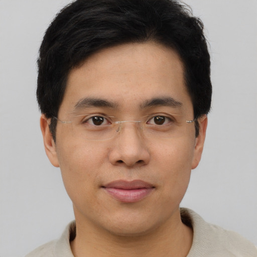 Joyful asian young-adult male with short  black hair and brown eyes