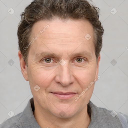 Joyful white adult male with short  brown hair and grey eyes