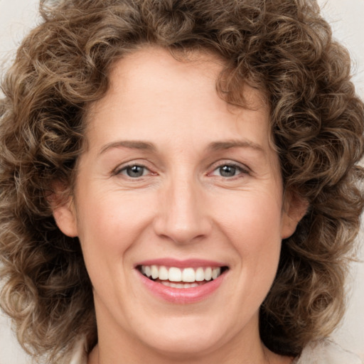 Joyful white young-adult female with medium  brown hair and green eyes