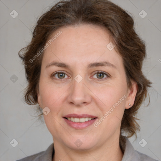 Joyful white adult female with medium  brown hair and grey eyes