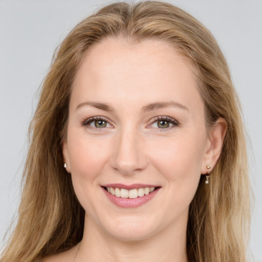 Joyful white young-adult female with long  brown hair and green eyes