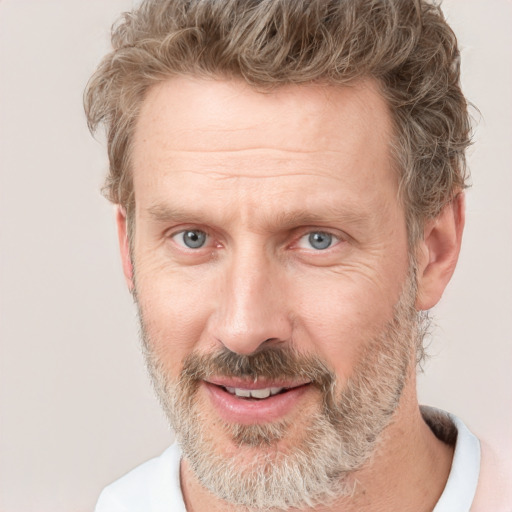 Joyful white adult male with short  brown hair and grey eyes